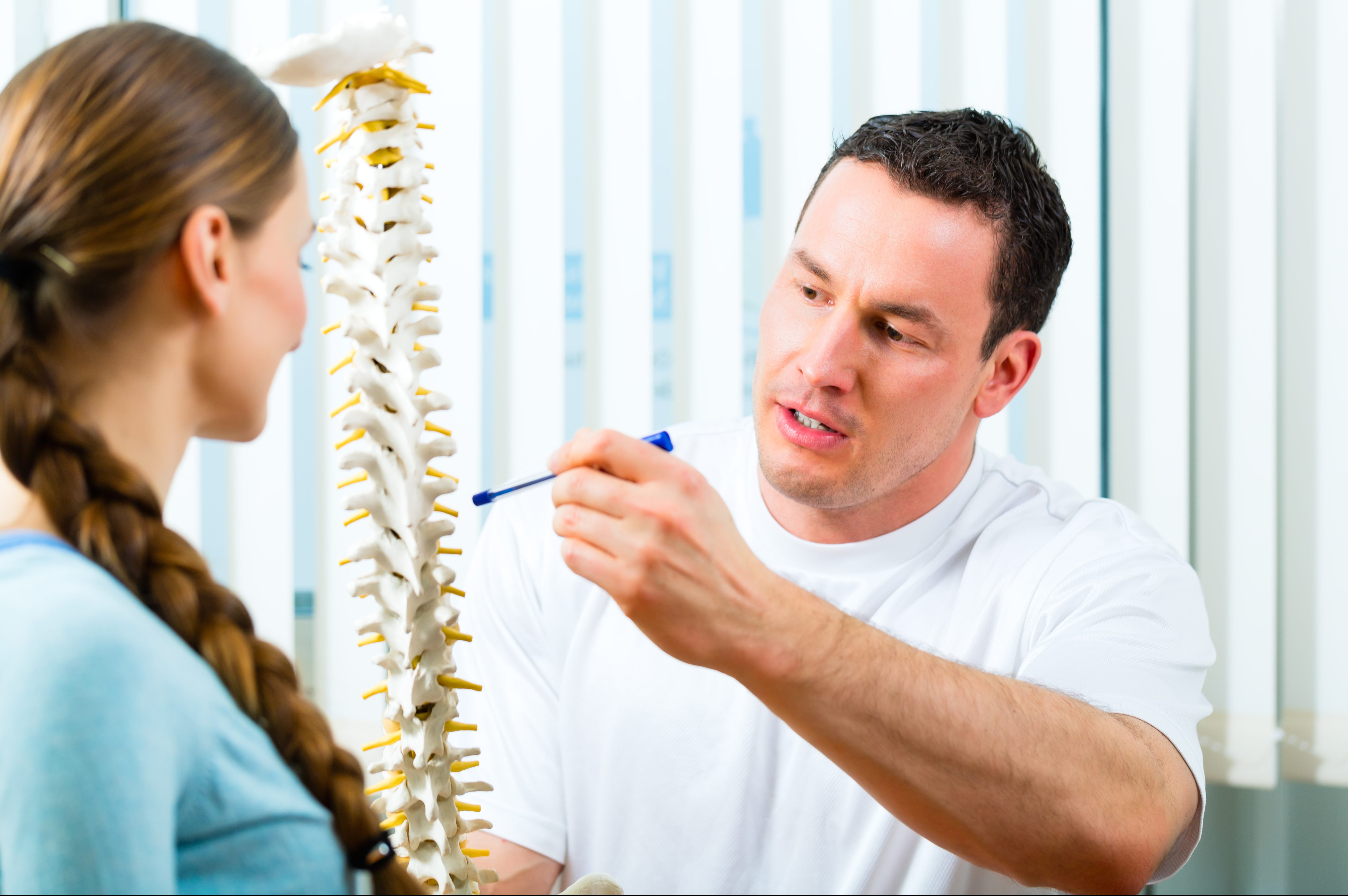 Physiotherapist,In,His,Practice,,He,Explains,A,Female,Patient,The